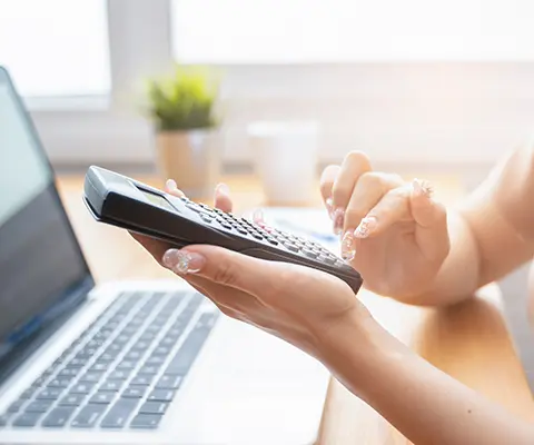 A woman using a calculator.