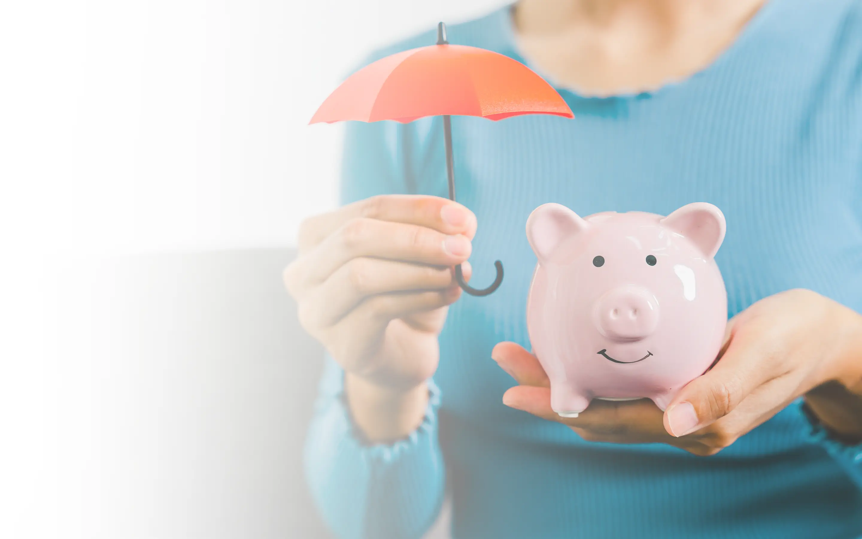 A woman holding a piggy bank and a red umbrella.